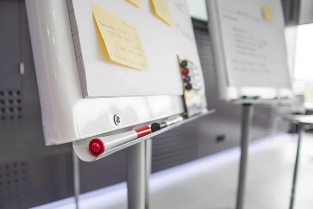 board, pens, sticky notes, workshop, business, office, paper, meeting, event, workplace, work, whiteboard. B2B demand generation team roles without the overlap